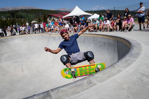 A professional skateboarder rides the rim of a bowl during Concrete Jams: Skate + Jazz.