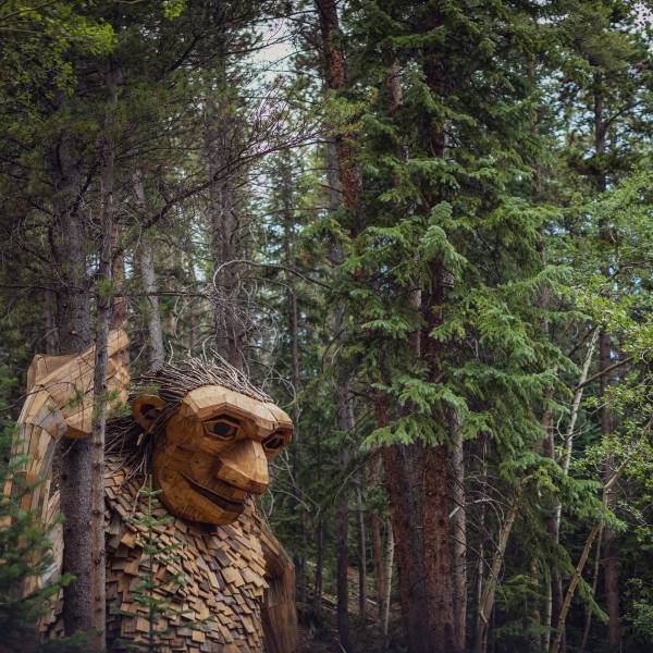 Isak Heartstone, a sculpture of a giant troll from reclaimed wood materials by artist Thomas Dambo, watches over a trail in Breckenridge..