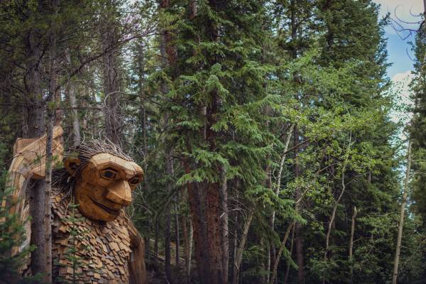 Isak Heartstone, a sculpture of a giant troll from reclaimed wood materials by artist Thomas Dambo, watches over a trail in Breckenridge..