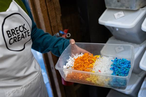 Shards of repurposed plastic are sorted and ready to feed into the Precious Plastic machine in order to create carabiners