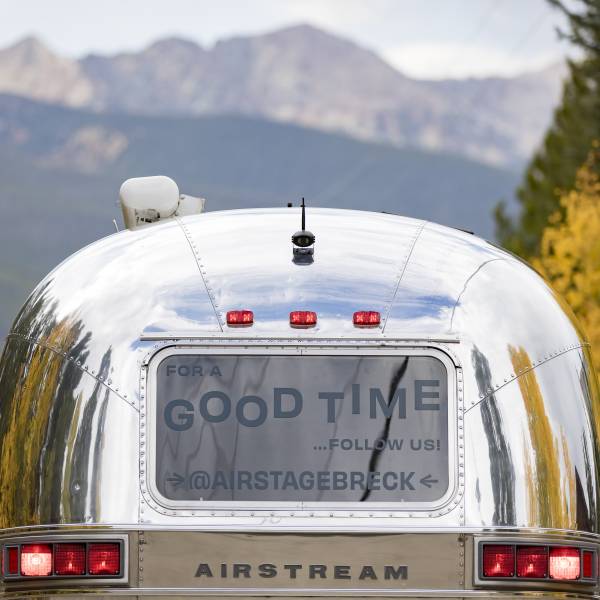 The Breck Create AirStage trailer - a stage on wheels with a back window that says, "for a good time, follow us @airstagebreck."