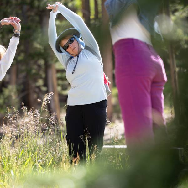 Attendees of a Guided Mindfulness Hike stretch together before the hike