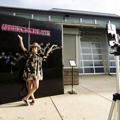 An attendee of the Breckenridge International Festival of Arts poses in front of the Breck Create selfie wall