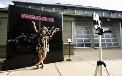 An attendee of the Breckenridge International Festival of Arts poses in front of the Breck Create selfie wall