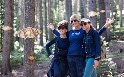 Hikers on a guided mindfulness hike to view an art installation set among the trees on a trail in Breckenridge