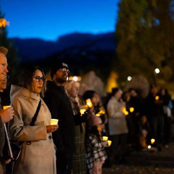Community members participate in a candlelight vigil during the Día de Muertos festival