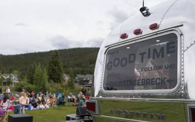 The AirStage, an Airstream trailer retrofitted into a mobile stage is featured at a neighborhood block party. The back window says, "for a good time, follow us @airstagebreck."