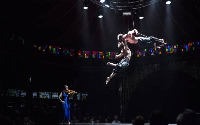 Circa contemporary circus company, an exploration of pure physical beauty that will challenge your perception of what is possible. Shown here with two male trapeze artists and a violinist.